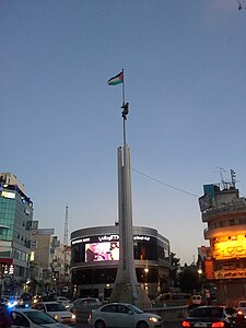 Monument and Palestinian flag at Al Sa’a Square/Yasser Arafat Square