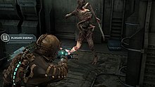 The image shows the player's character, Issac Clarke, pointing his weapon at a deformed humanoid. He has a lit cyan "spine" along the back of his space suit, indicating the player has maximum health points.