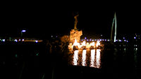 Keeper of the Plains in December, 2010 at night. View from the banks of the Arkansas River, with the "Ring of Fire" aflame.