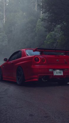 red nissan parked on the road live wallpaper