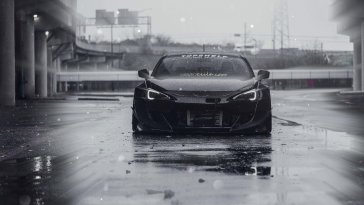 black sports car in the wet streets live wallpaper